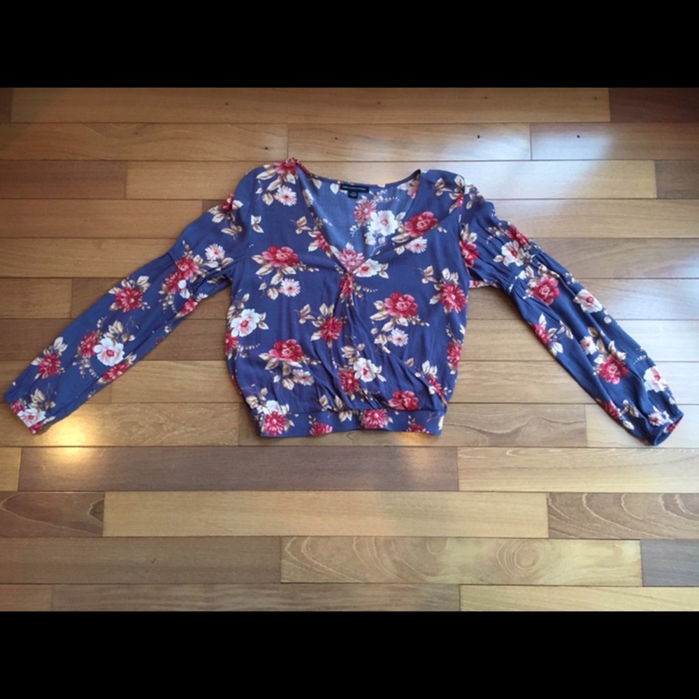 Blue floral V-neck blouse.